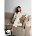 Women's white floral print pyjama set with bell sleeve top and wide-leg trousers