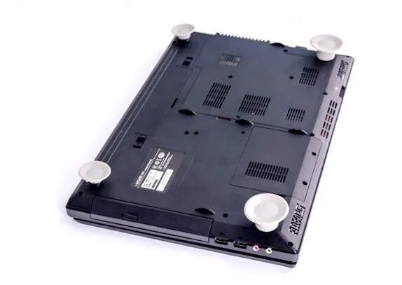 Grey plastic laptop cooling pads, two large and two small, placed under a mini notebook.