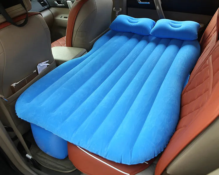 Black inflatable car bed with flocked surface, two pillows, and storage bag for five-seater vehicles
