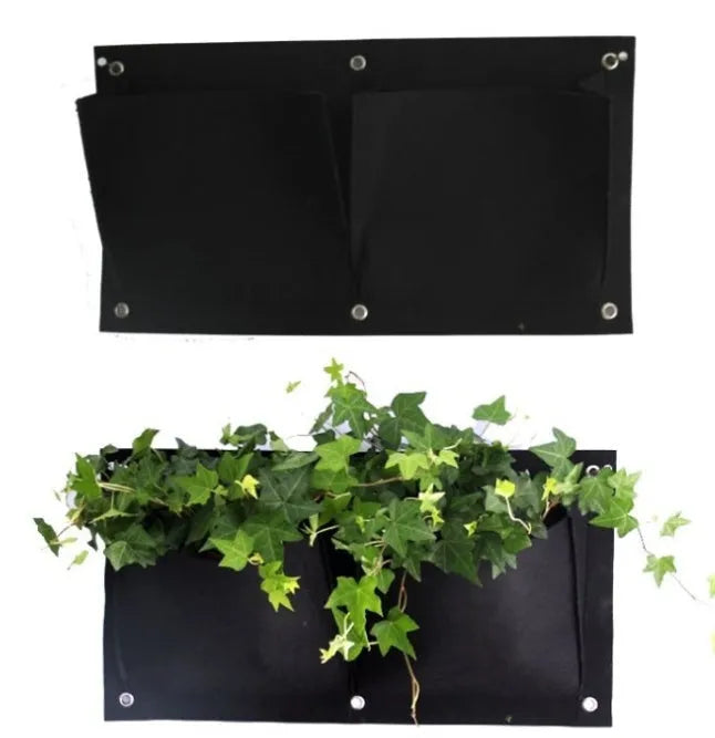 Vertical green felt wall hanging planter with multiple pockets full of herbs and flowers