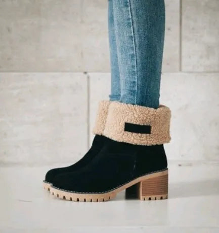 Women's black suede mid-tube snow boots with a round toe and thick low heel on a waterproof platform.