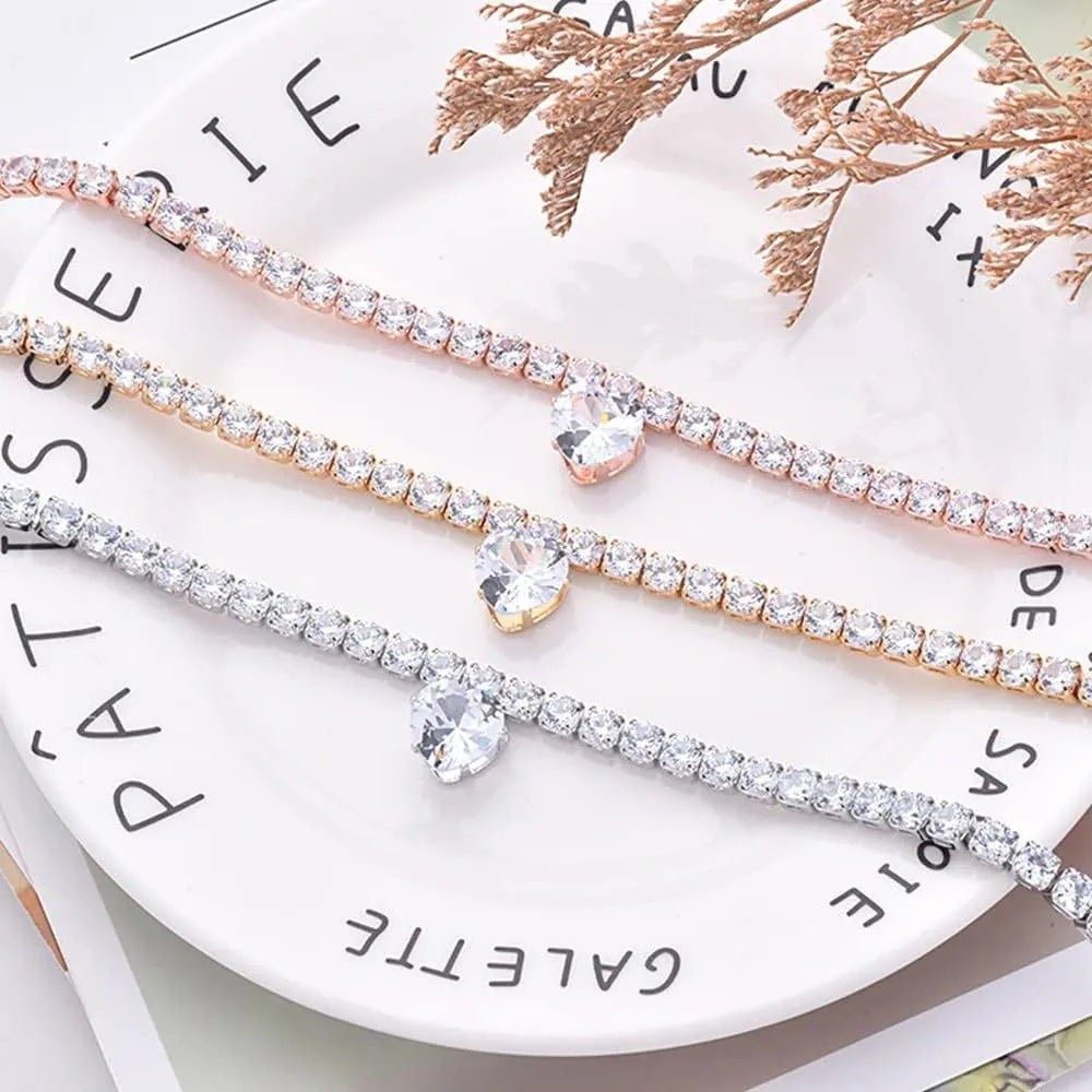 Gold rhinestone heart-shaped decorative collar for a dog or cat on a white background.