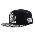 Black cotton baseball hat with white embroidered letters on the front, showing the dome crown shape.