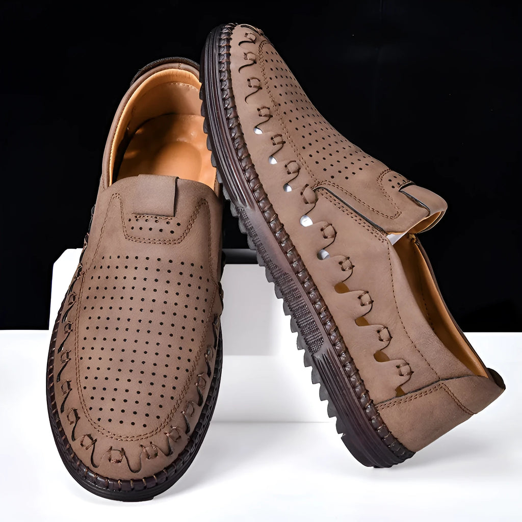 Men's brown slip-on casual leather shoes with round toe and flat PVC sole on a white background.