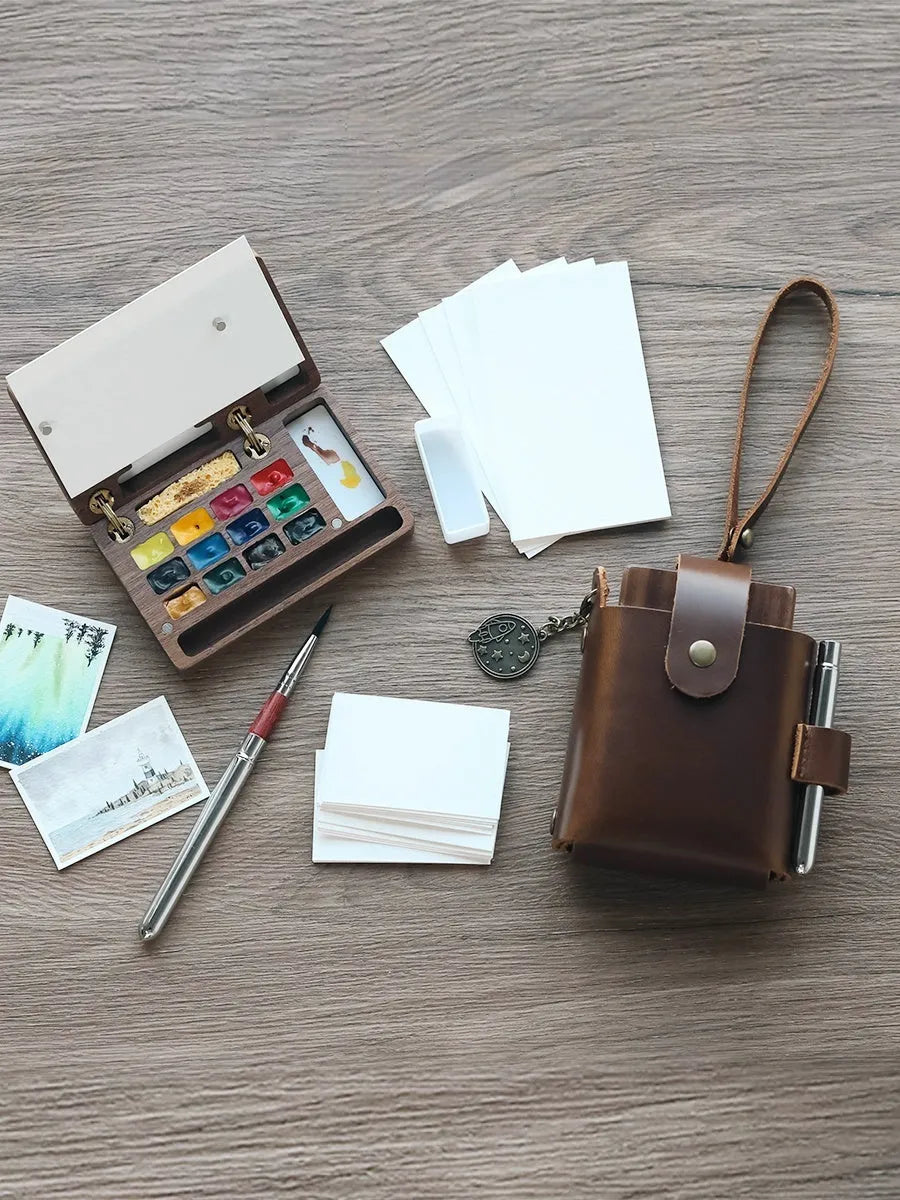 Mini walnut wooden watercolour paint box open to show pigment suit inside