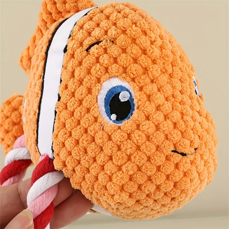 Grey, green, and orange turtle-shaped plush dog toy with a knotted rope chewing core