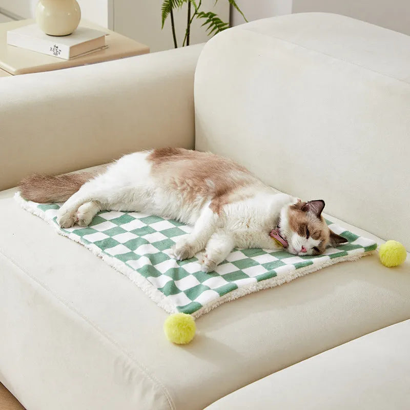 Plush fleece pet blanket with plaid pattern and fur ball decoration for cats and dogs