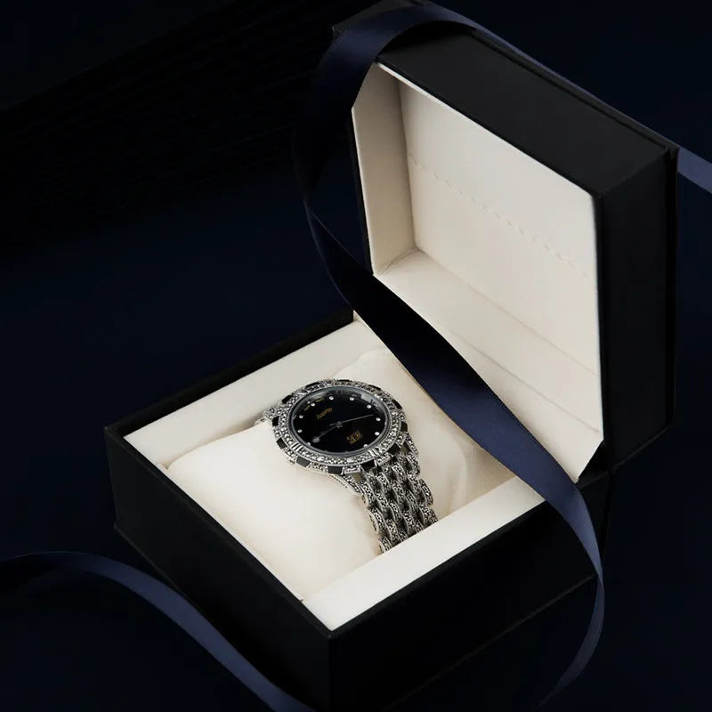 Quartz movement luxury romantic watch with metal strap, round dial, and jewellery buckle in black plate