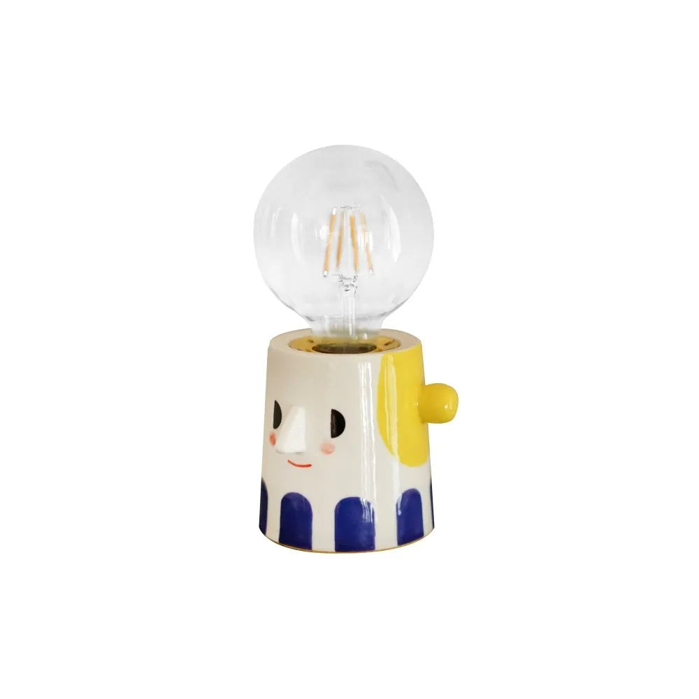 Handmade ceramic table lamp with ball headlight shade on wooden surface