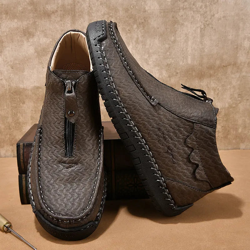 Men's black slip-on leather loafers with a round toe and visible stitching on a sewn rubber sole.