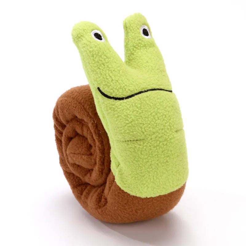 Shape-changing dog puzzle toy shown as a snail and a stick, with hidden food holes and a squeaker.