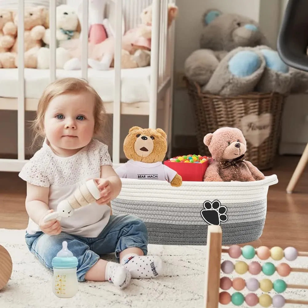 Small light beige handmade cotton rope storage basket with a wooden handle.
