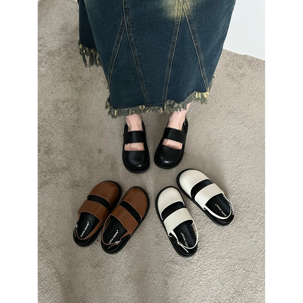 Retro closed toe sandals with an ankle buckle in apricot colour on a white background