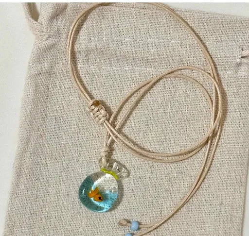 Women's joker pendant necklace with coloured glaze ornament on a cotton and linen clavicle chain.
