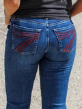 Slim fit denim jeans with a mid-waist and slightly flared leg, shown in an embroidered colour variant.