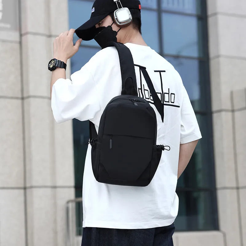 Men's grey waterproof chest bag with adjustable shoulder strap showing front compartment
