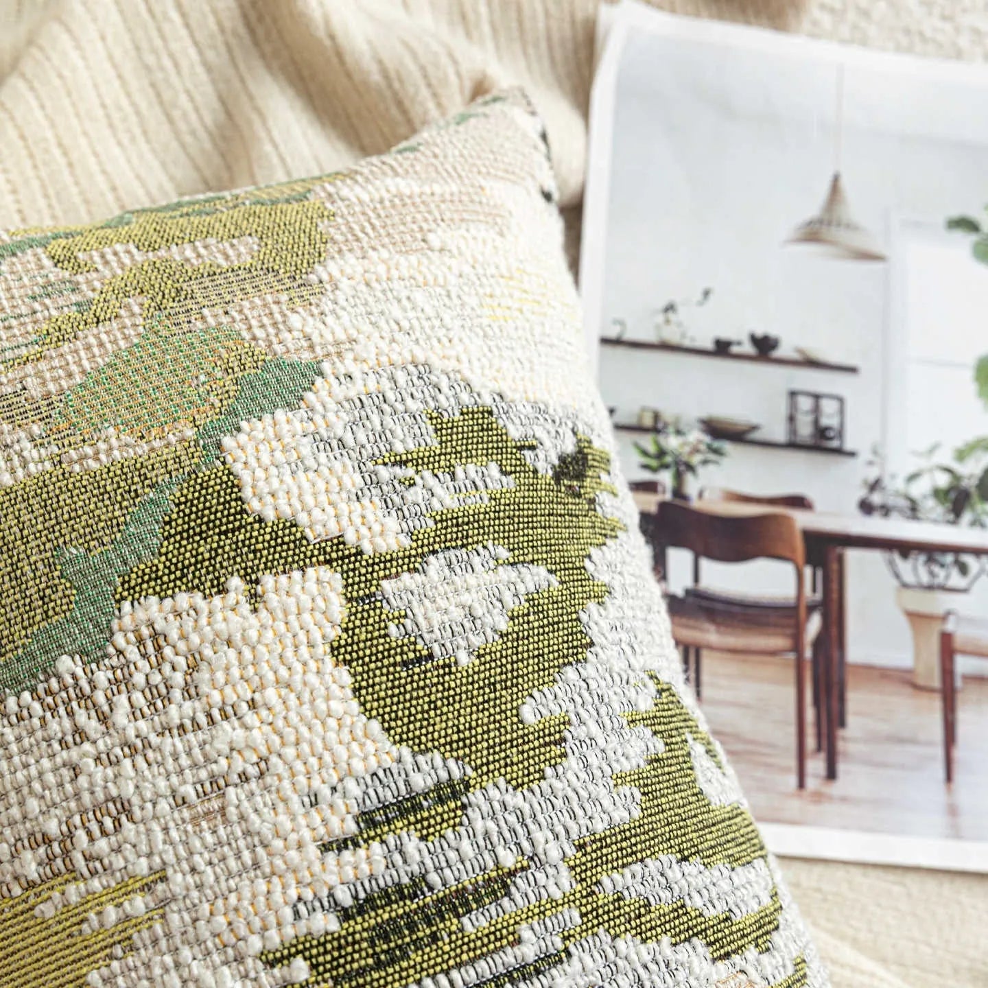 Green abstract plants and flowers pattern wool blend cushion cover on a sofa, showing square and waist pillow sizes.