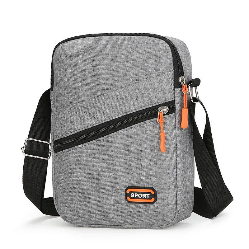 Ultra-light Oxford cloth crossbody commuter bag in black, navy blue, or silver grey with contrast colour detailing.