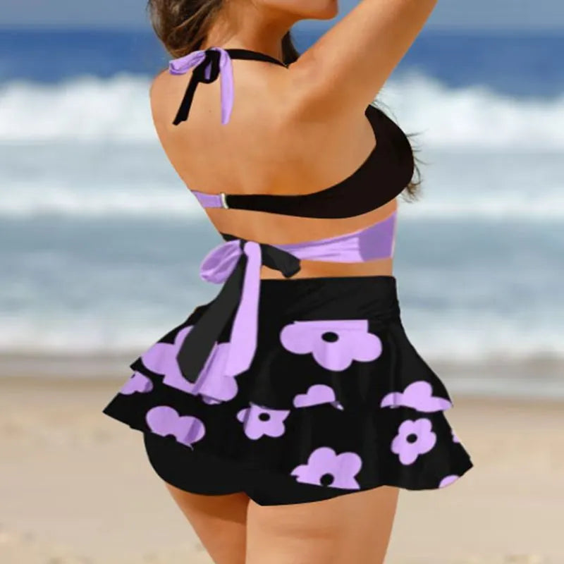 Women's purple bikini set with lace-up detail on split skirt and high-waist briefs.
