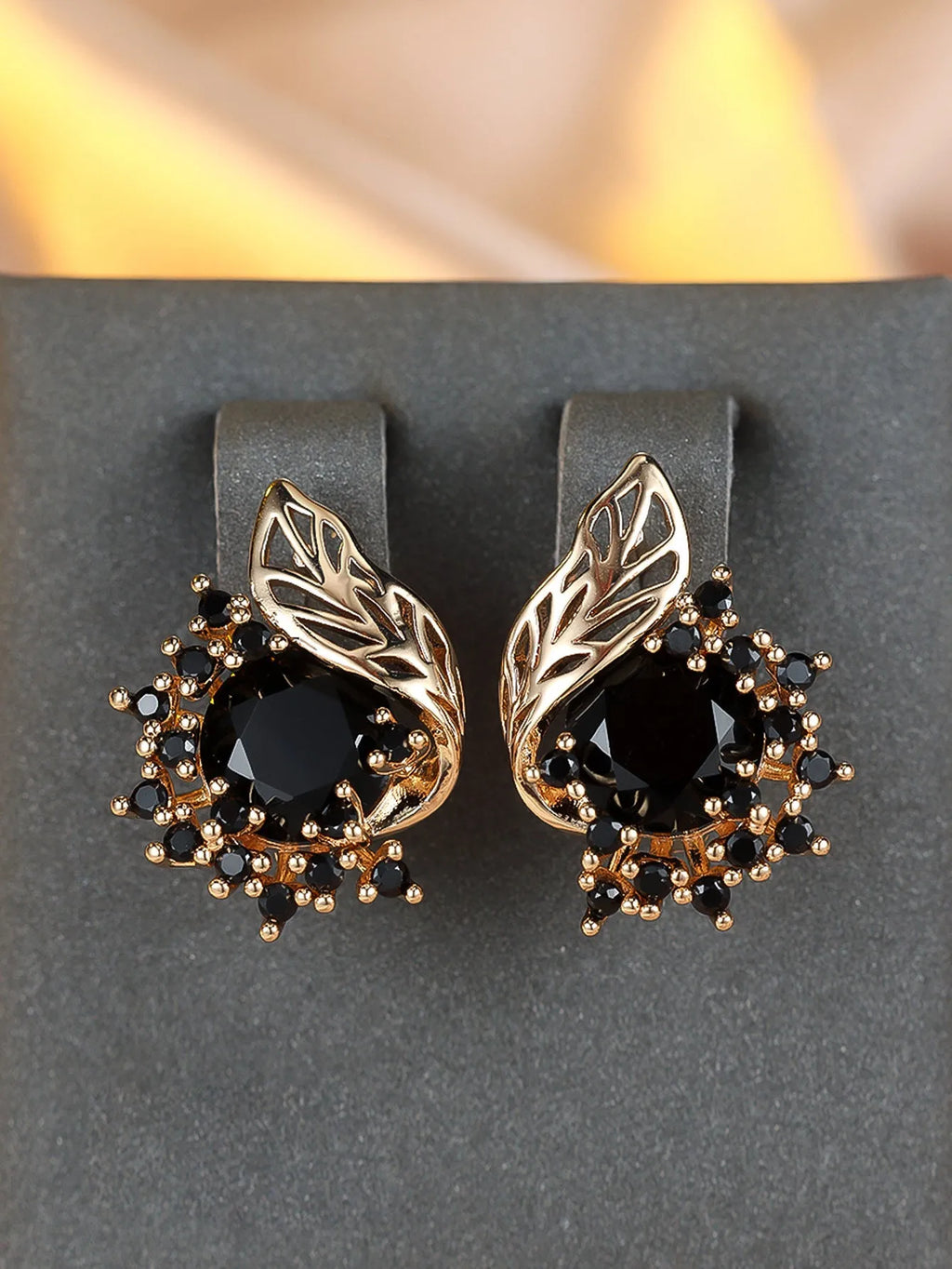 Rose gold coloured feather and flower design earrings with a choice of coloured zircon centre stones.