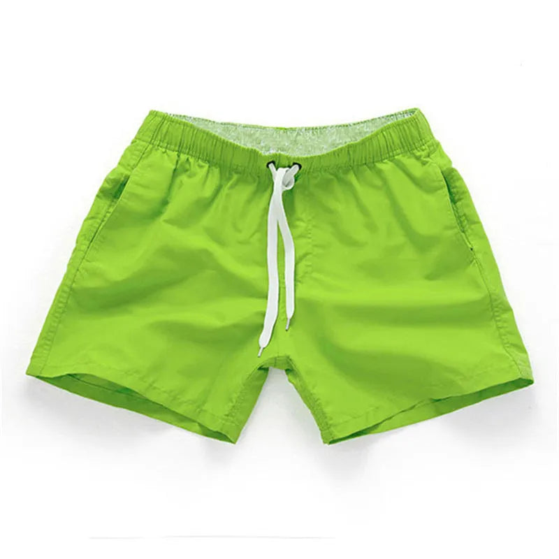 Men's straight-leg polyester beach shorts on a hanger, showing the classic fit and available in multiple solid colours.