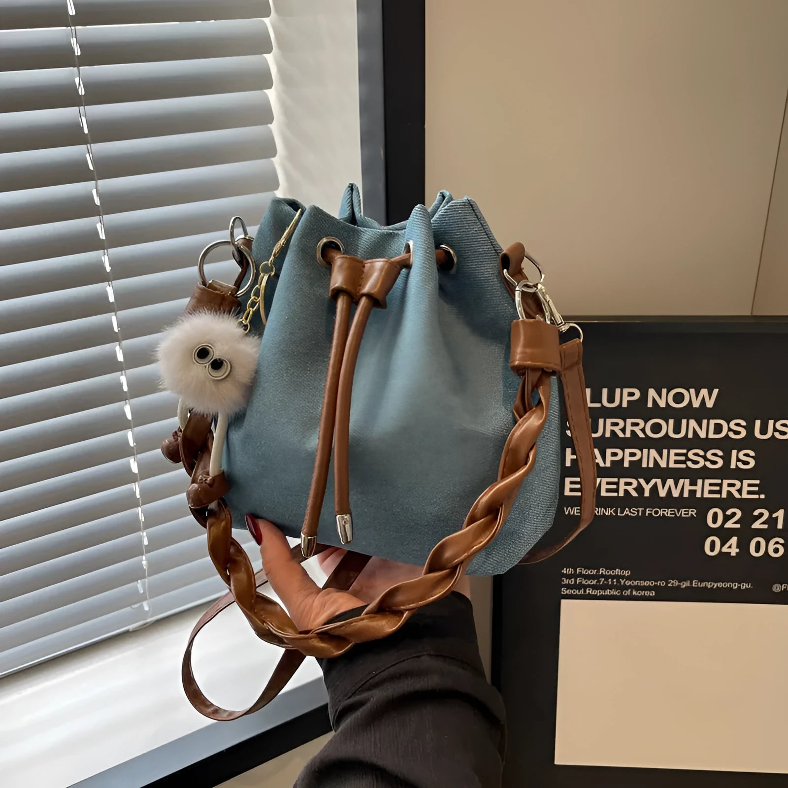 Blue one-shoulder cross-body bucket messenger bag with synthetic leather lining