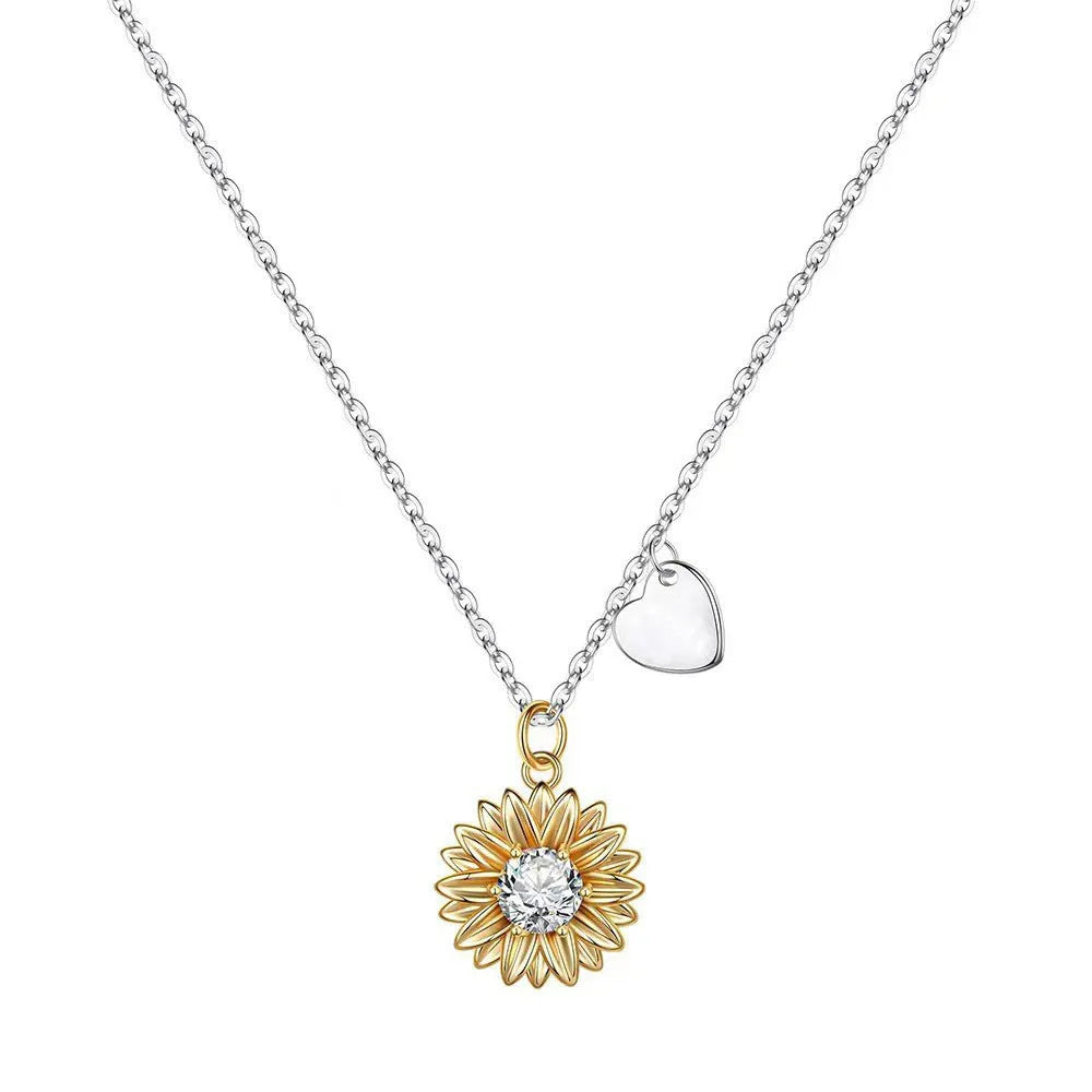 Sterling silver sunflower pendant necklace with adjustable chain on grey background