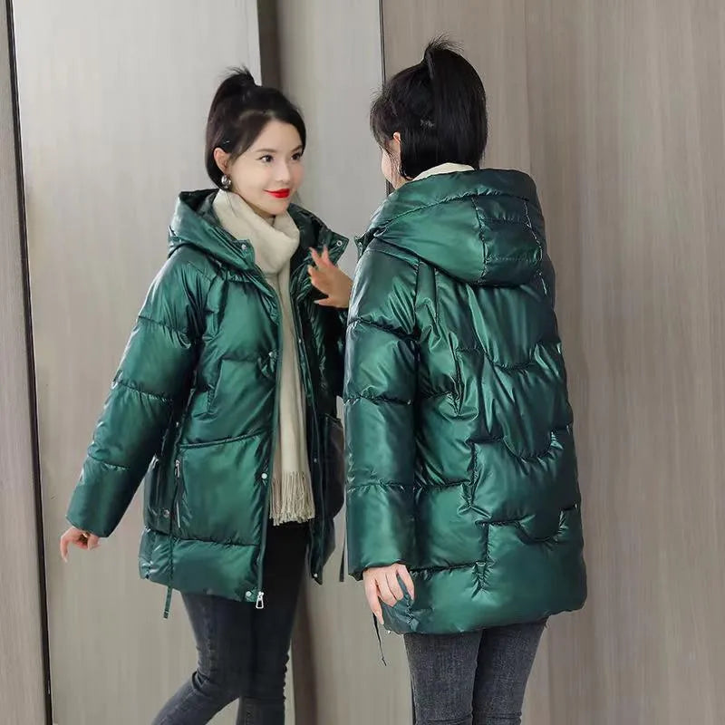 Women's loose thick hooded winter jacket in green colour shown on a model.