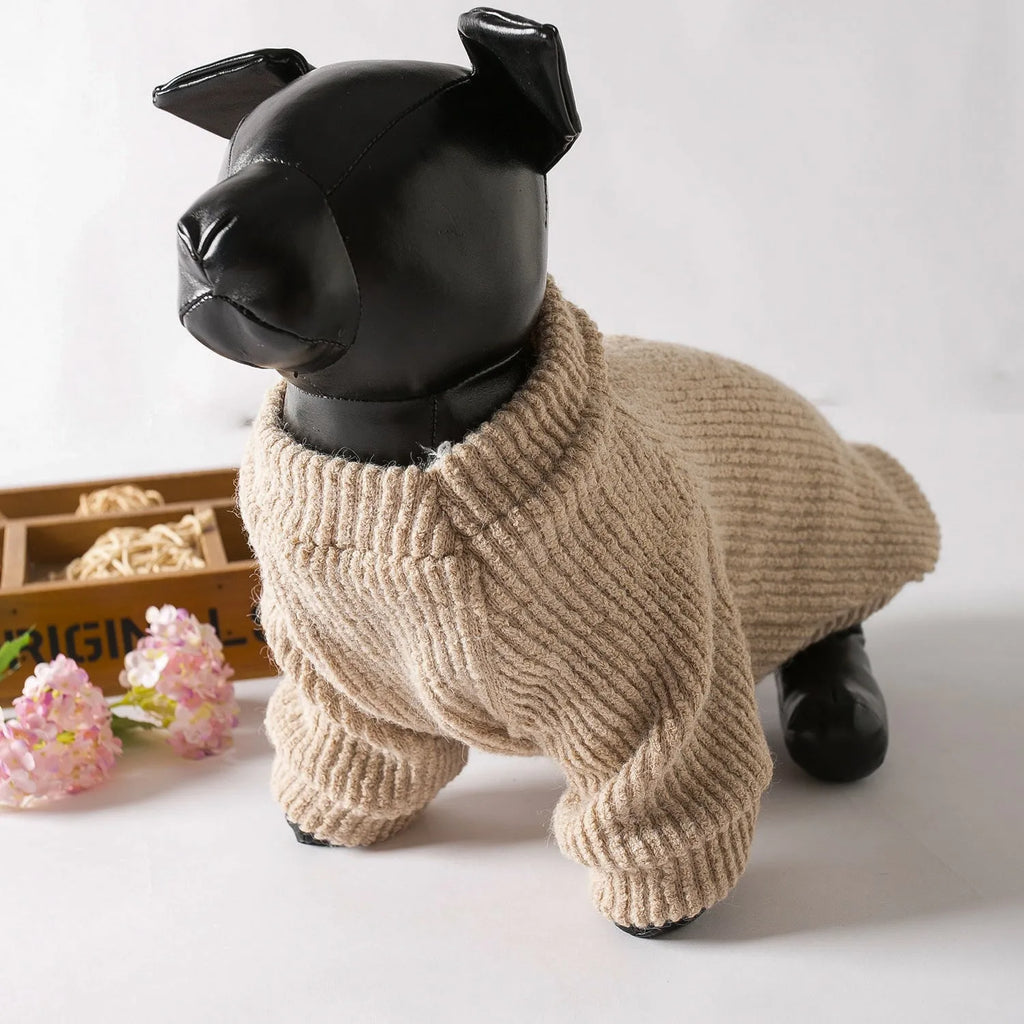 Brown knitted dog sweater on a small white dog, showing a casual pullover style.
