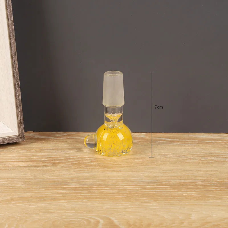 A transparent coloured glass trumpet-shaped smoking pipe, 7cm long, on a plain background.
