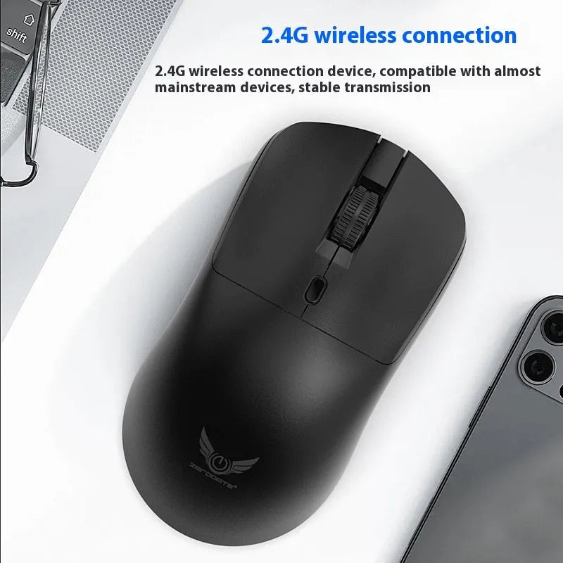 Black wireless laptop mouse with three-gear audio button shown on desk