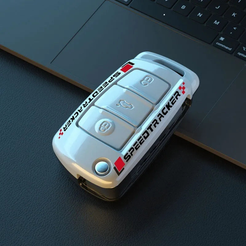 Carbon fibre pattern car key cover with a small rectangular mirror set into the feilin material casing.