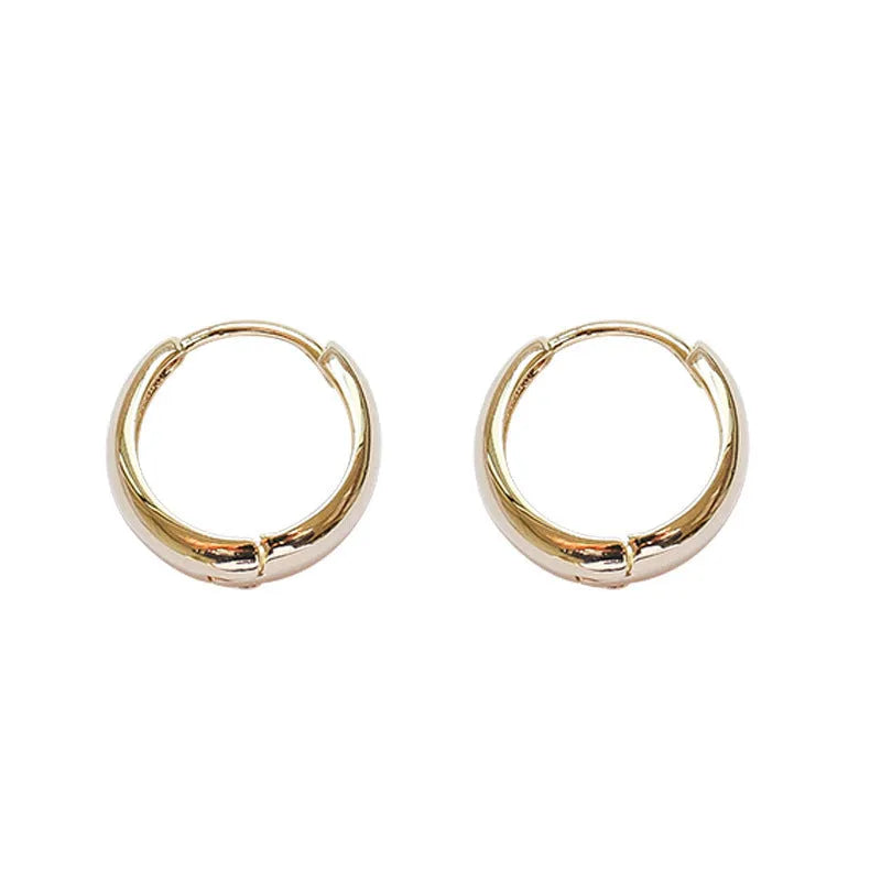 Women's minimalist water drop earrings in electroplated gold or silver copper, showing geometric shape and round elements.