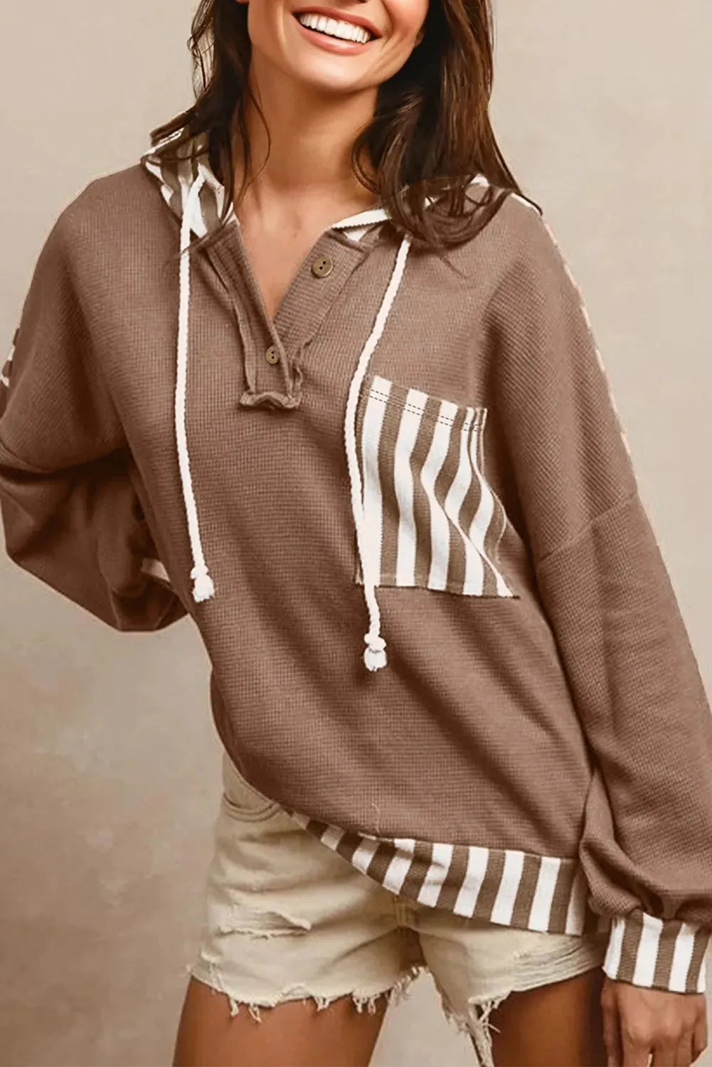 Straw yellow hoodie with waffle texture striped patchwork design featuring drawstring hood and button neck closure