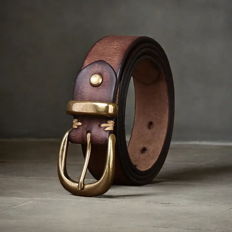 Men's black genuine leather casual belt with a copper pin buckle on a jeans background.