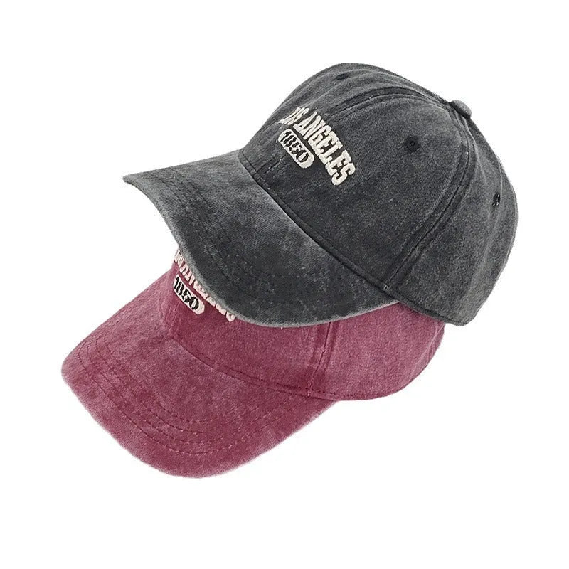 Retro personalised distressed acrylic peaked cap with embroidered letters, shown on adjustable strap.