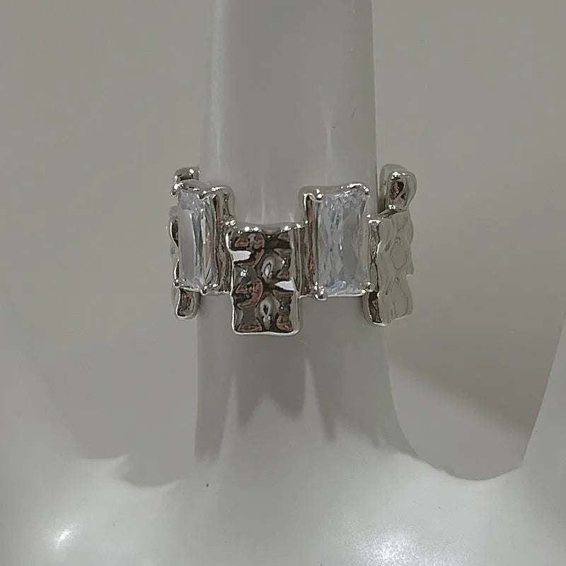 Silver geometric cross ring with open zircon gemstone setting and three-dimensional decoration