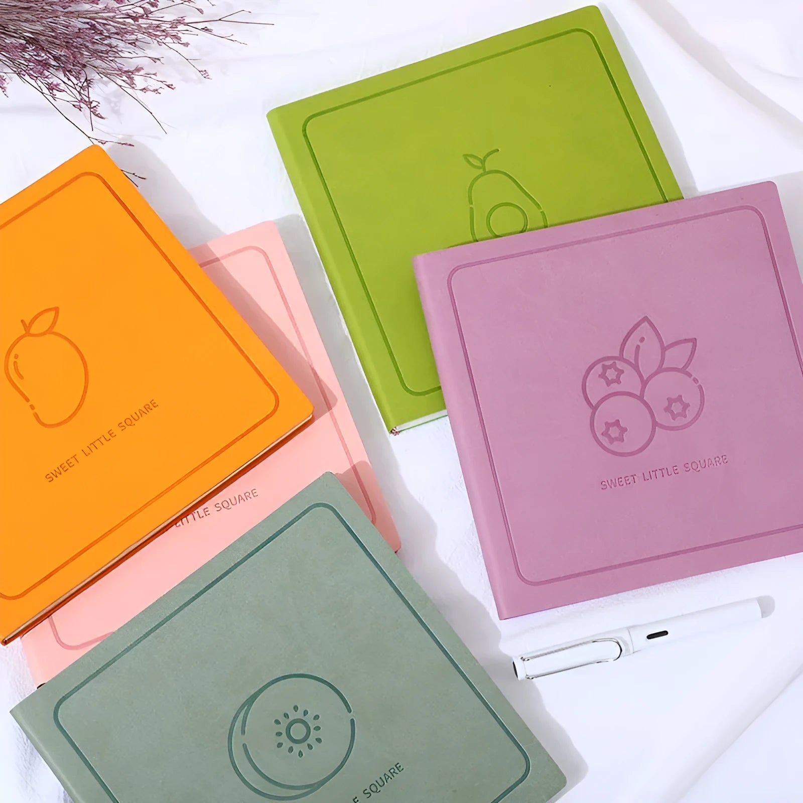 A5 square notebook with faux leather cover showing colour options and open blank pages