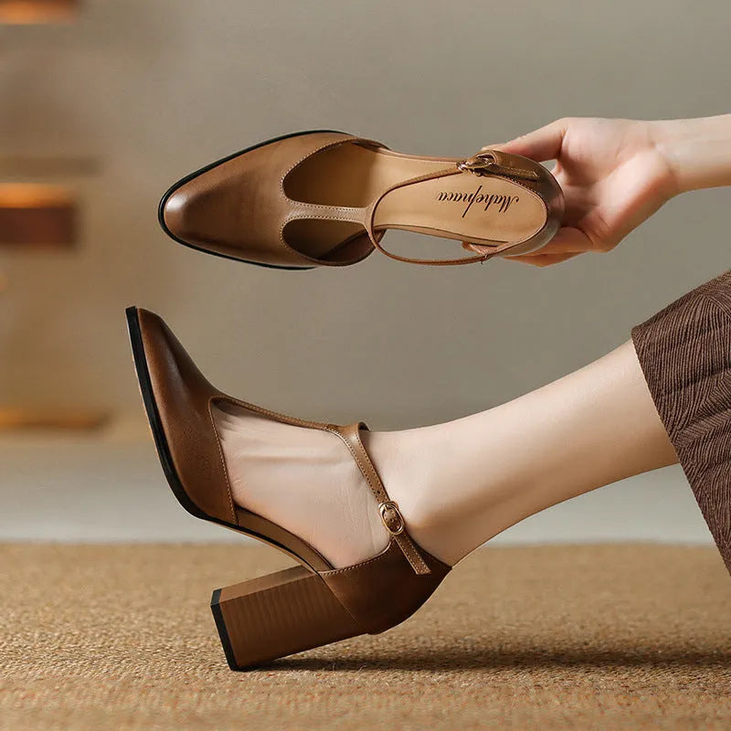 Women's dark brown retro Mary Jane shoes with a pointed toe, hollow Baotou detail, and buckle fastening.