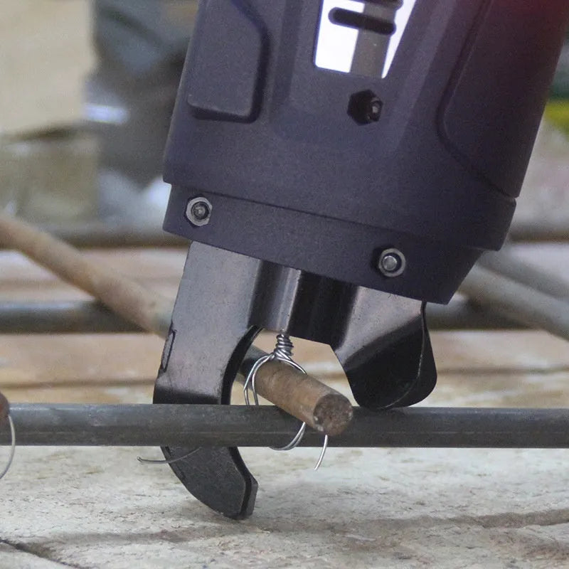 Automatic electric steel bar tying machine with battery and coil of wire for construction sites.