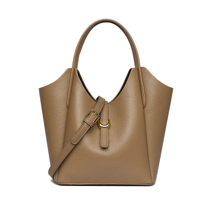 Genuine leather women's hand holding bucket bag in retro style with file compartment interior.