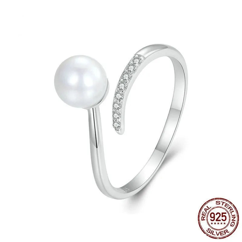 Adjustable sterling silver ring with natural shell pearls on open loop design