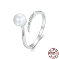 Adjustable sterling silver ring with natural shell pearls on open loop design