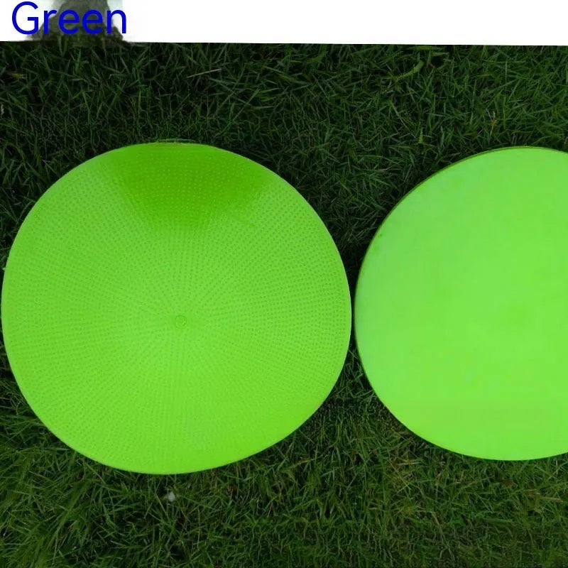 Yellow soft TPE football training target disc lying flat on grass