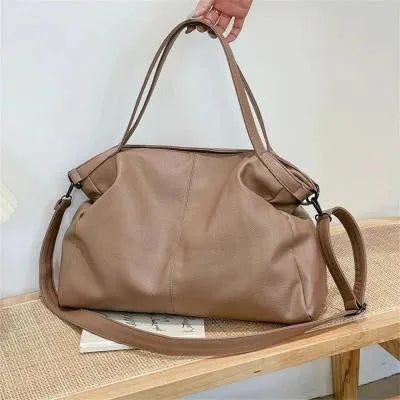 Large soft surface PU messenger tote bag in a horizontal square shape with a zip top and long shoulder strap.
