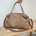Large soft surface PU messenger tote bag in a horizontal square shape with a zip top and long shoulder strap.