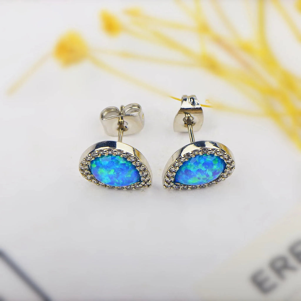 Blue opal drop-shaped stud earrings on copper base with inlaid gem setting