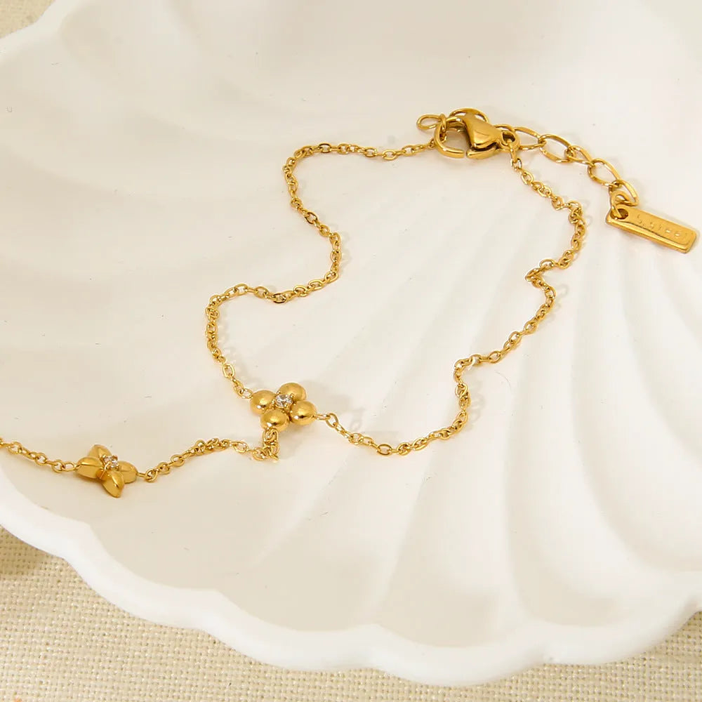 Gold geometric women's bracelet with floral and eight-pointed star design elements