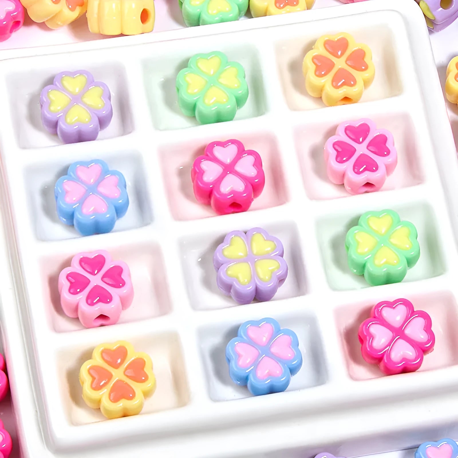 Mixed colour frosted acrylic four-leaf clover shaped beads, each 15mm in size.
