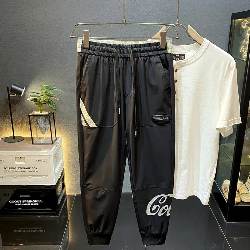 Men's solid black ultra-thin ice silk cotton trousers with a cropped leg and elasticated ankle band.